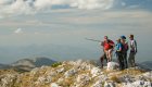 A group of men overlooking the Peaks of the Balkans in Albania while on a hiking tour