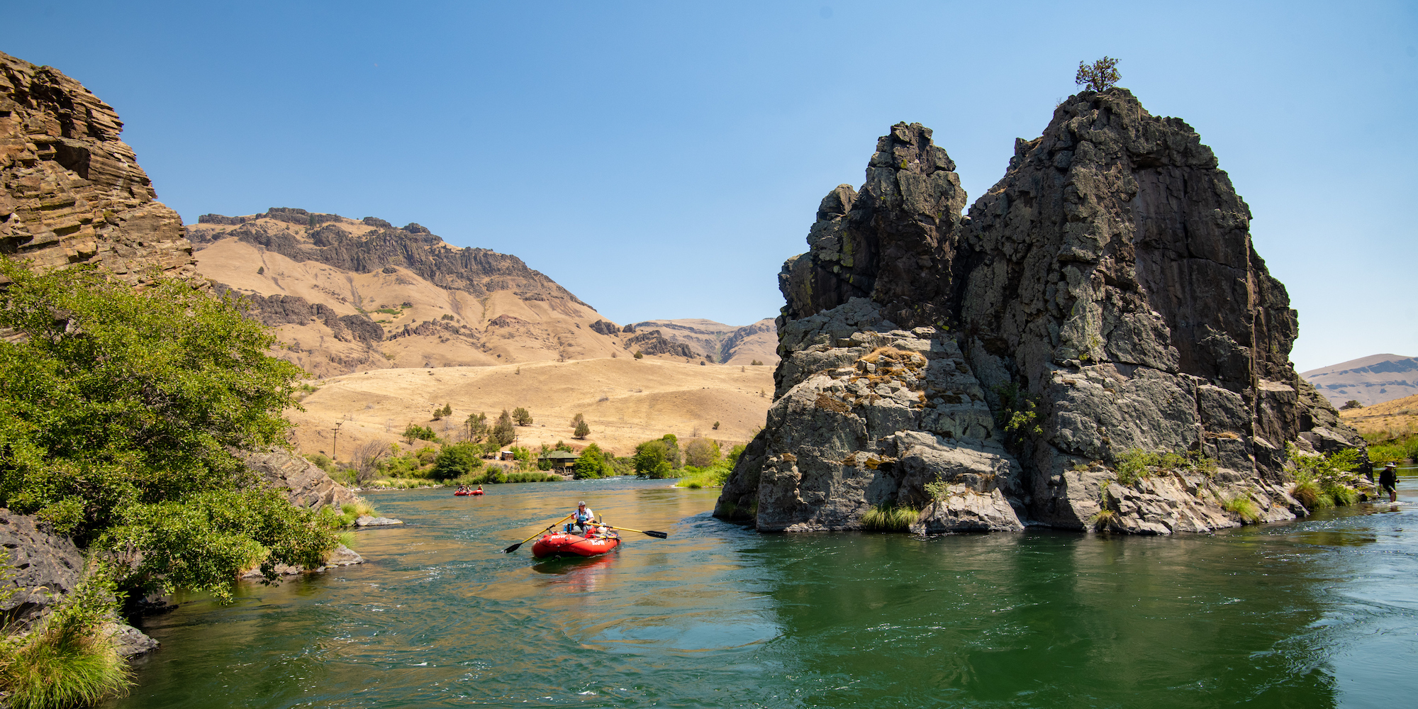 A red raft floating down the Deschutes River near Portland Oregon
