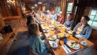 Group of guests around the dinner table at Black Bar Lodge in Oregon
