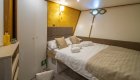 Cabin of luxury yacht in Croatia with one twin bed made neatly. 