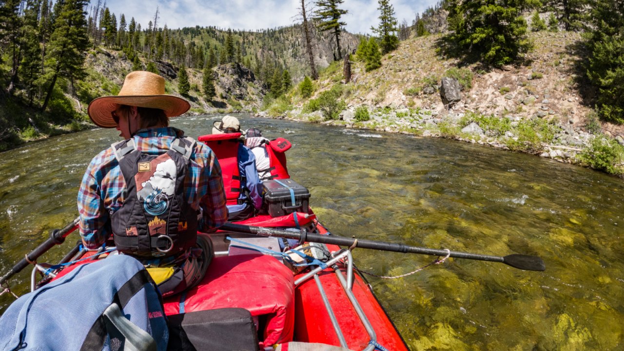 Welcome to your office! raft guide on a stern mount raft with two people