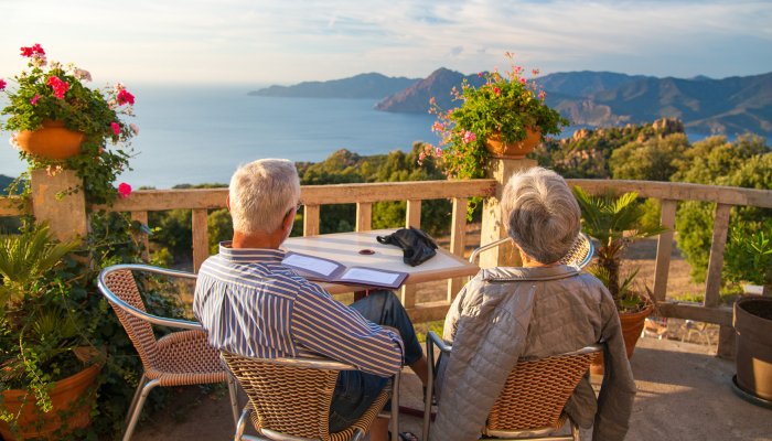 Couple eating at a restaurant overlooking the Mediterranean Sea