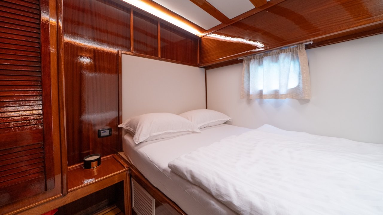 Croatia yacht cabin with one neatly made bed.