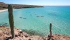 Kayakers in Isla Espiritu Santo among desert hills and cacti