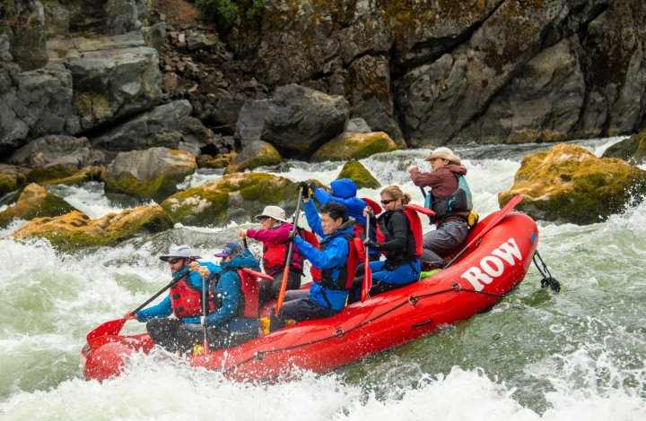 red paddle raft on the snake river going through rapids
