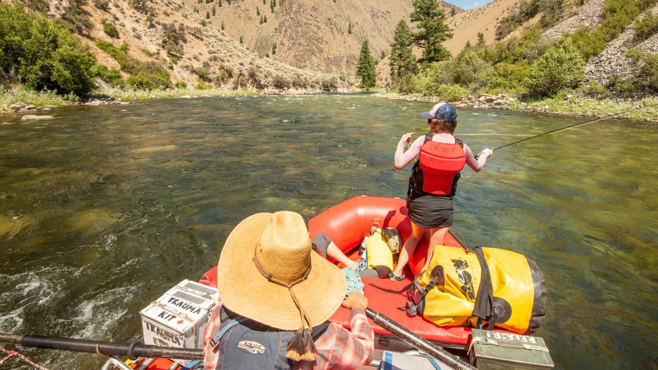 Woman casting a line off of a raft on the Salmon River
