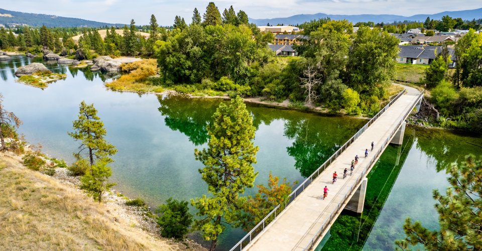 People biking across a bridge