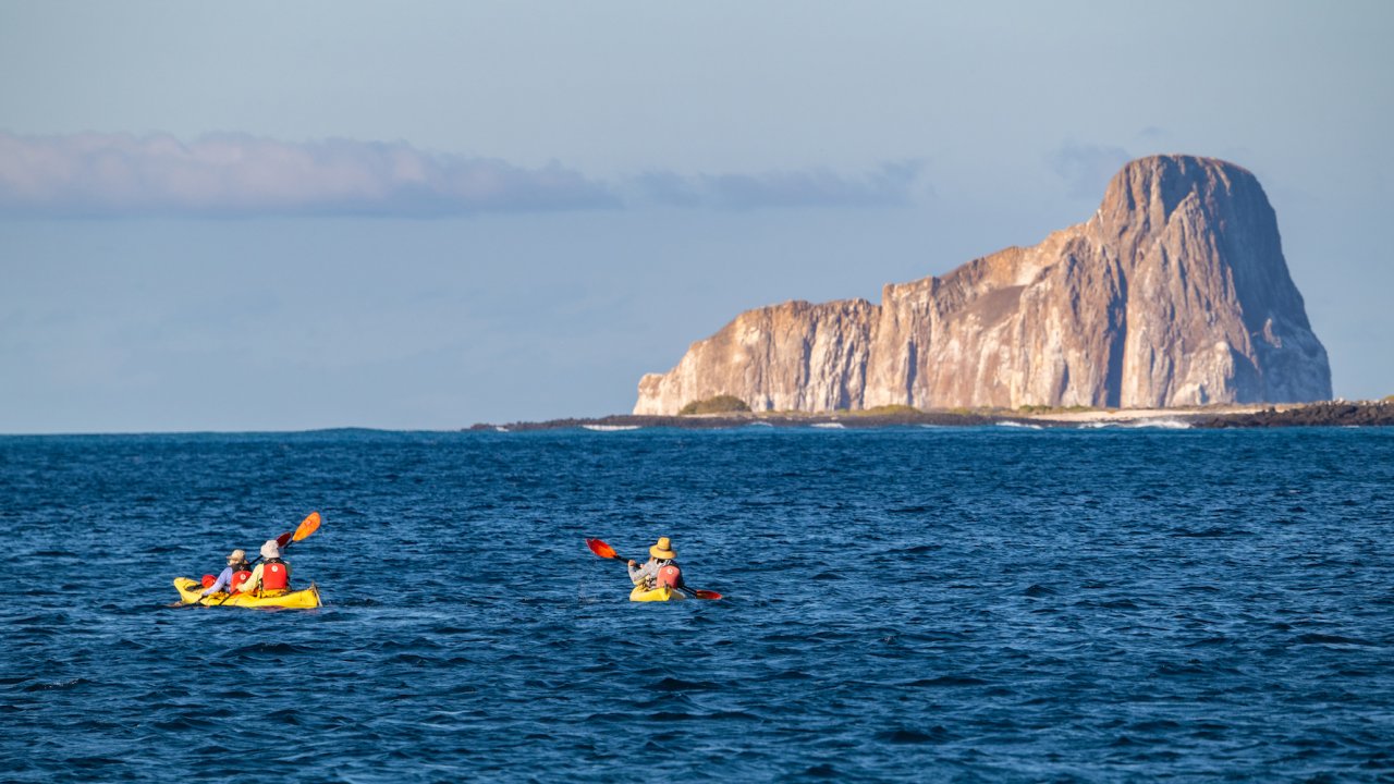 Two sea kayaks paddling near Kicker Rock in the Pacific