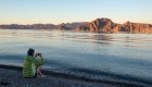Guest admiring the view of the desert mountains from the beach in Baja, California Sur