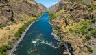 Birds eye view of red ROW rafts floating down stream on the Snake River