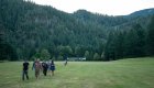 People walking down an airstrip with Half Moon Bar Lodge in the background