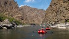 Red inflatable rafts floating downstream on the Snake River