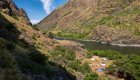 Snake River campsite tucked between steep canyon walls along the Snake River Canyon Trail, a multi-day Hells Canyon hiking adventure.