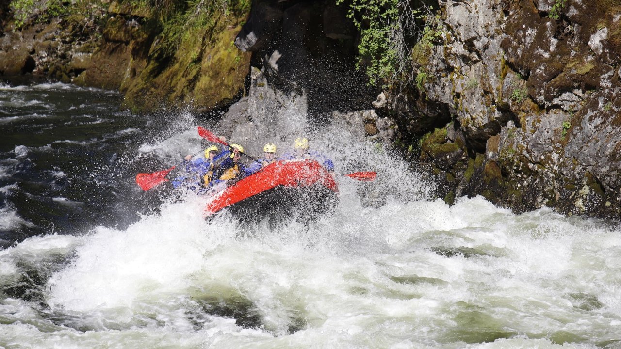 Raft going through a large and splashy rapid on the Lochsa river.