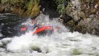 Raft going through a large and splashy rapid on the Lochsa river. 