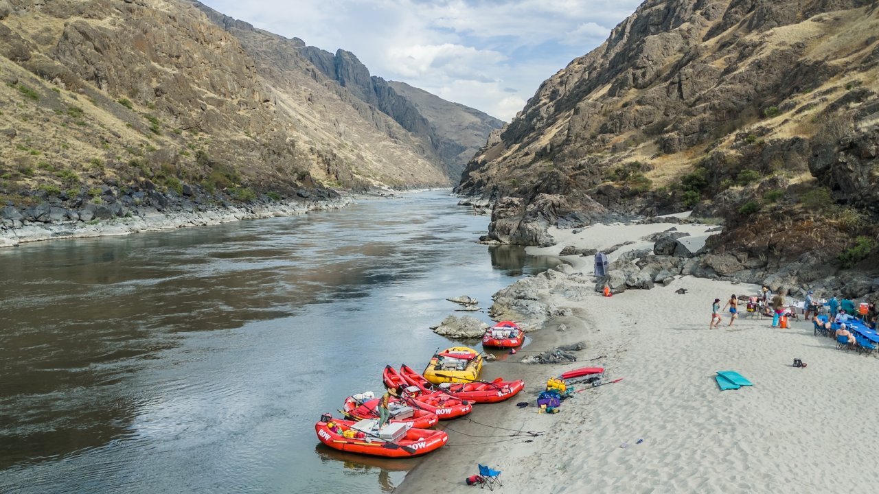 Rafts and sandy riverside campsite along the Lower Salmon River in Idaho, a popular rafting destination through Salmon River canyons.