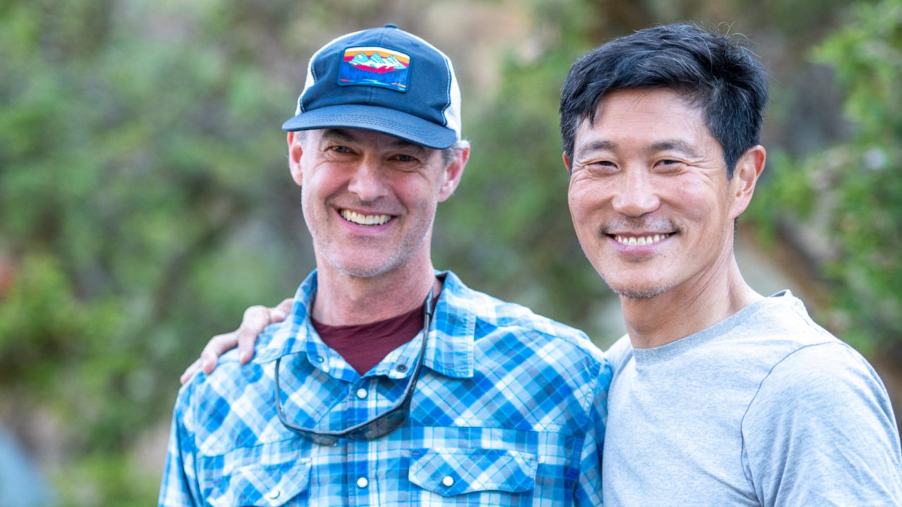 Two men smiling on a rafting trip