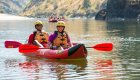 Two people in an inflatable kayak on still water