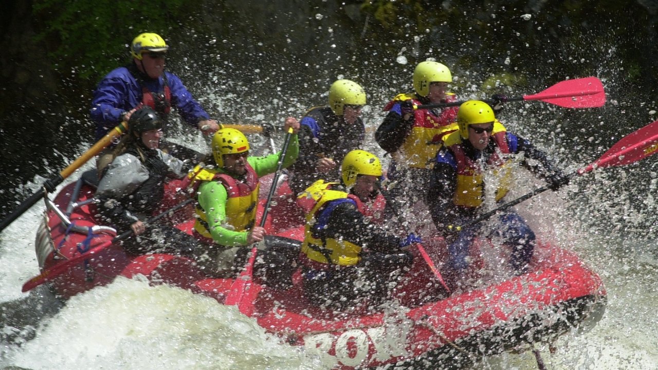 whitewater raft with people in splashy water