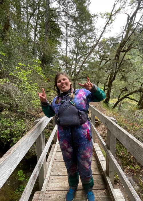 female river guide on wooden bridge