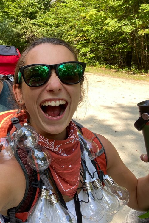 girl with lightbulbs around her neck and big smile