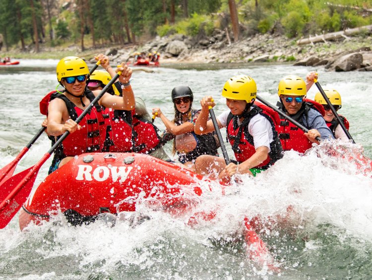 People in a red whitewater raft paddling the Middle Fork of the Salmon River in Idaho