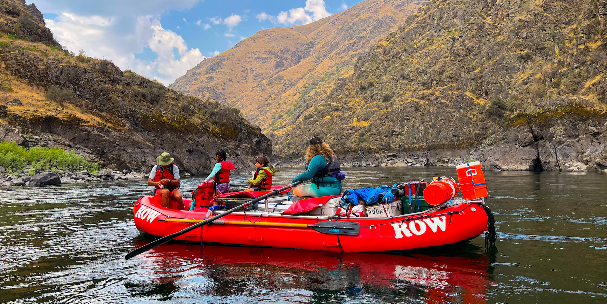 A red ROW raft floats down the Salmon River Canyons in Idaho