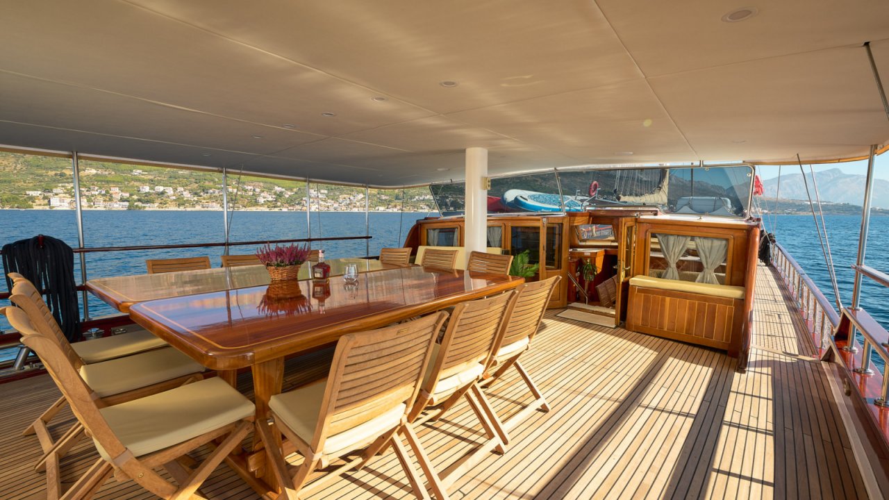 wooden dining table on deck of yacht