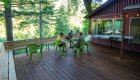 People relaxing on a wide open desk amongst the trees in the Rogue River Wilderness