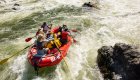 red whitewater raft in rapids