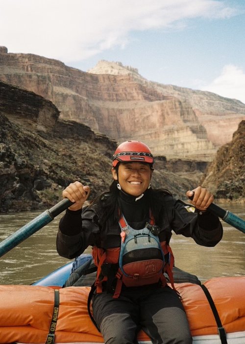 ROW Adventures raft guide on a raft going down the river.