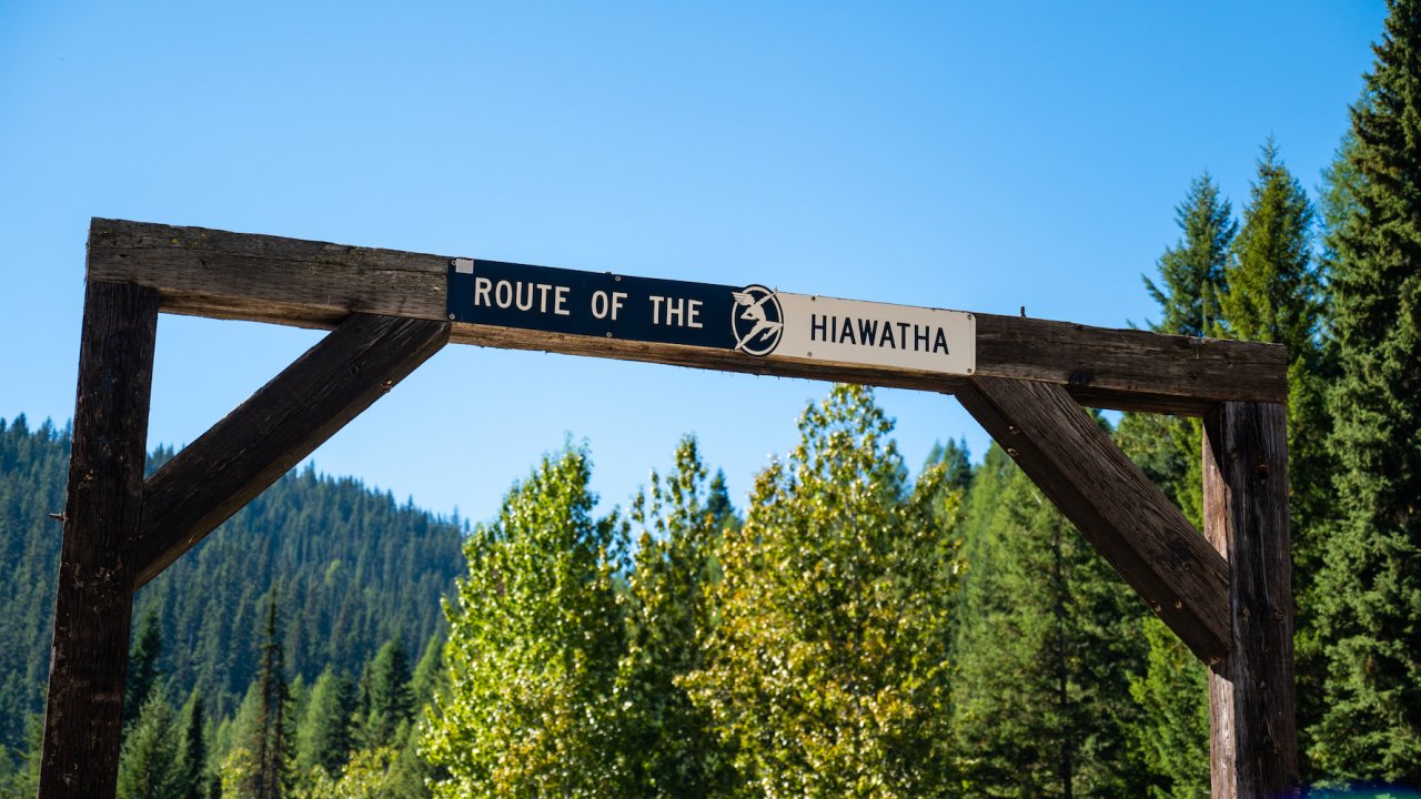 Sign on a wooden arch indicating the start of the Trail of the Hiawatha in Northern Idaho