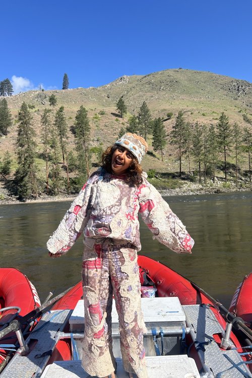 ROW employee smiling on a whitewater raft.