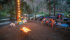 People sitting around a campfire along the Salmon River