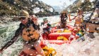 A group of people paddling through a whitewater rapid on the Salmon River Canyons