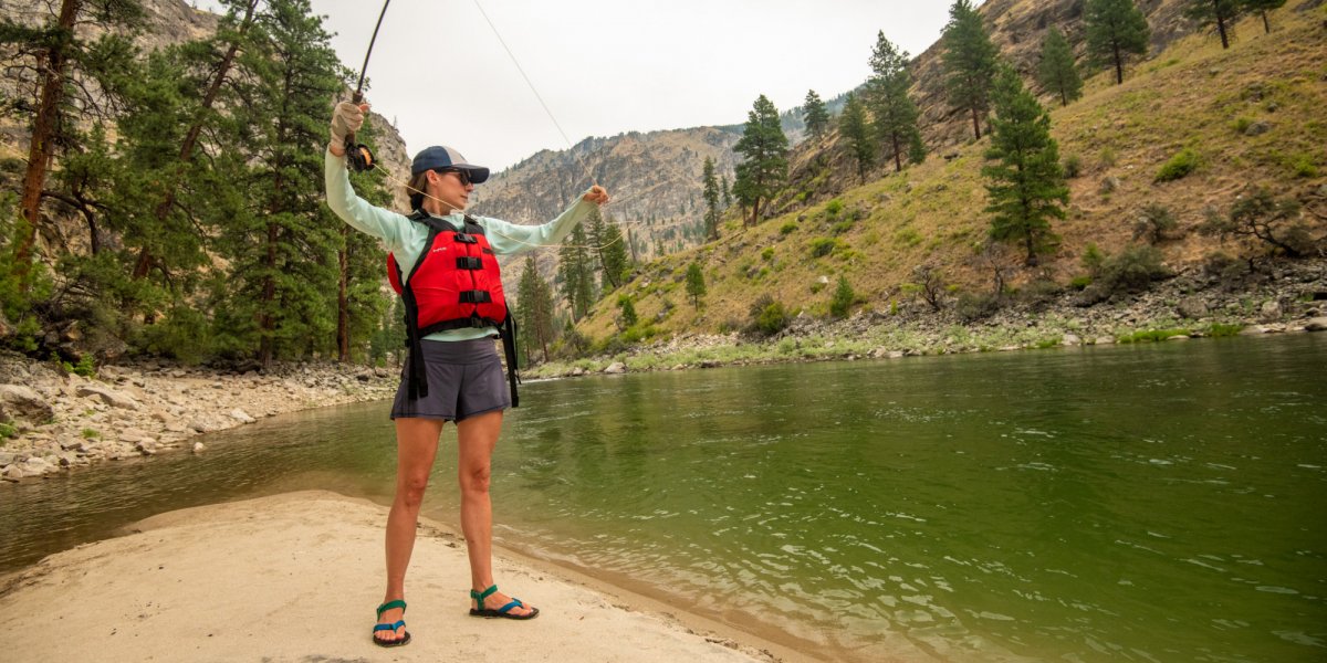 A ROW Guest practices her cast during some downtime at the river camp