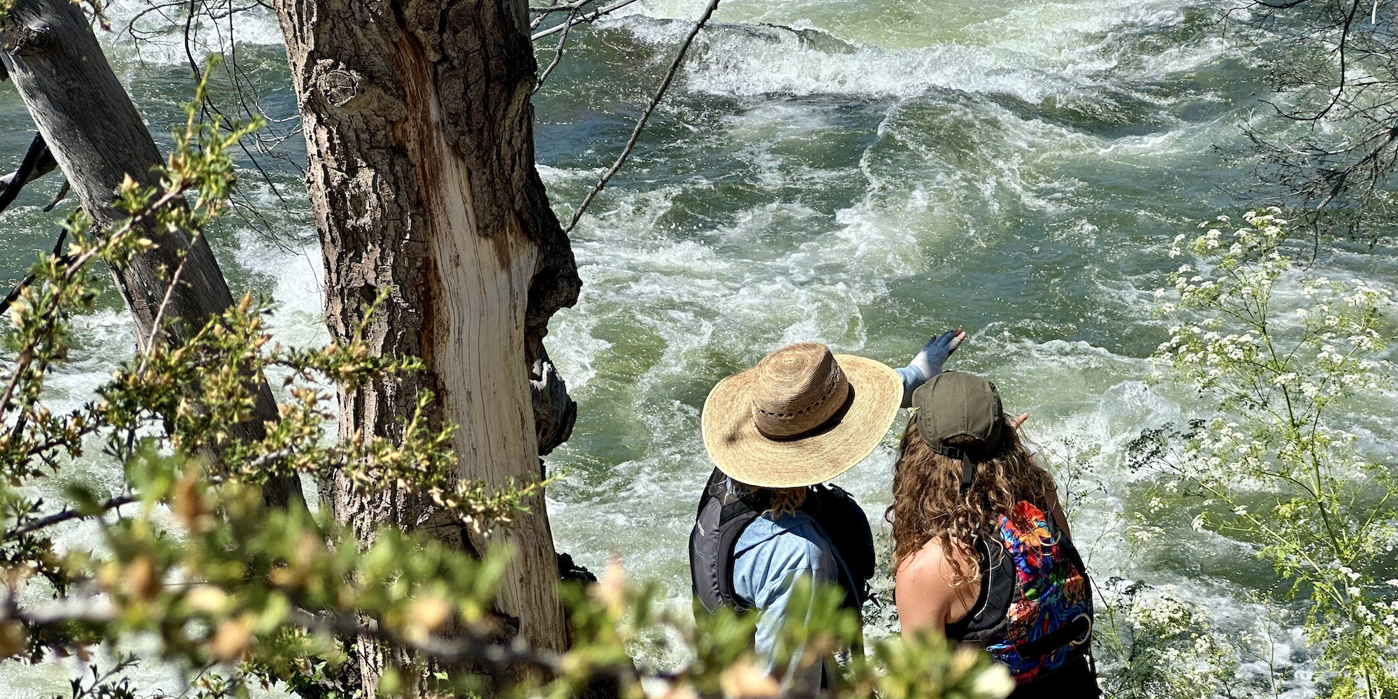 Two women scouting a class IV rapid on the Deschutes River