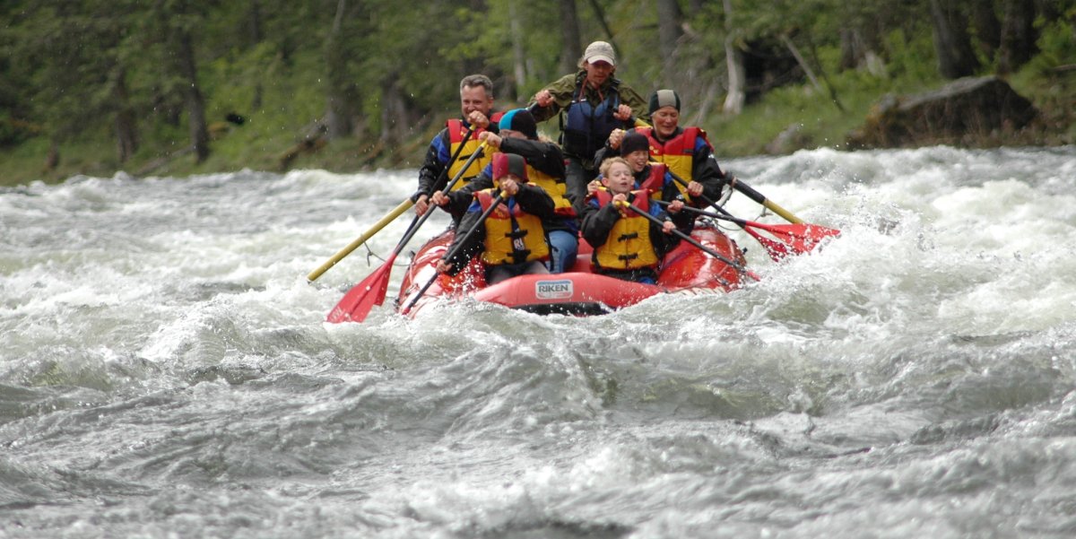 Commercial river boat full of exciting passengers paddling through a rapid on the Selway River, Idaho.