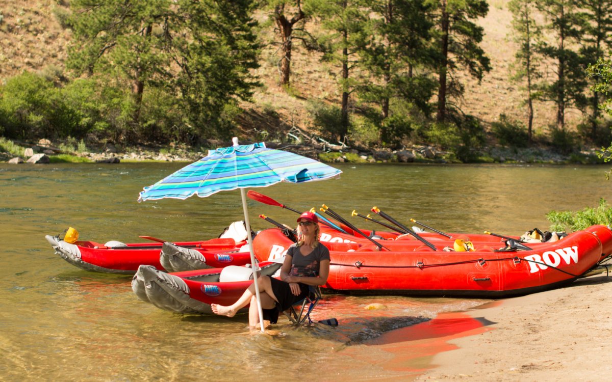 A Row Adventures group member sitting in the shade