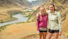 Two hikers on the Snake River Canyon Trail in Hells Canyon, Idaho, overlooking the winding Snake River during a scenic hike in Hells Canyon.