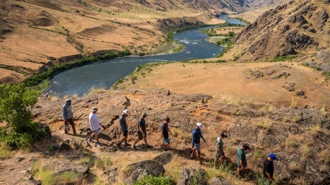 A group of people hiking along the Snake River in Hells Canyon