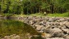Group of people biking along a paved trail next to a river in Olympic National Park