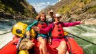 Excited mother and daughter riding whitewater rapids on the Middle Fork of the Salmon River during a guided Idaho rafting trip.