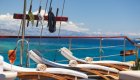 Three lounge chairs on the sun deck of a yacht, overlooking the blue Adriatic Sea. 